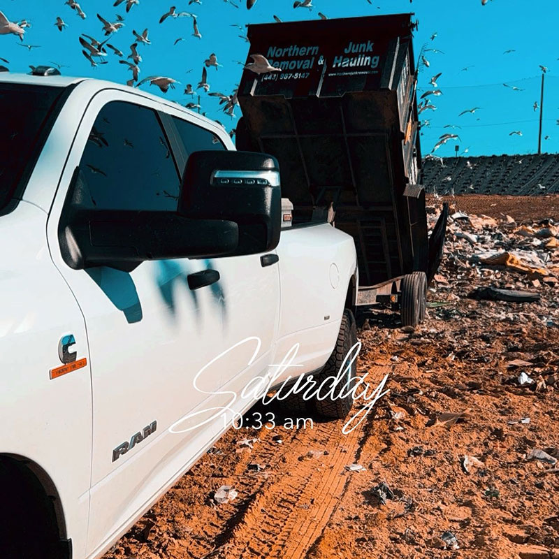 Truck dumping trailer load at landfill