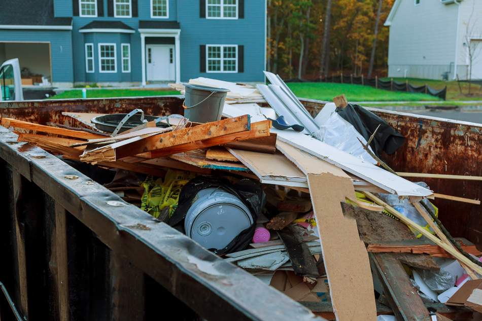 Large dumpster filled with building rubble